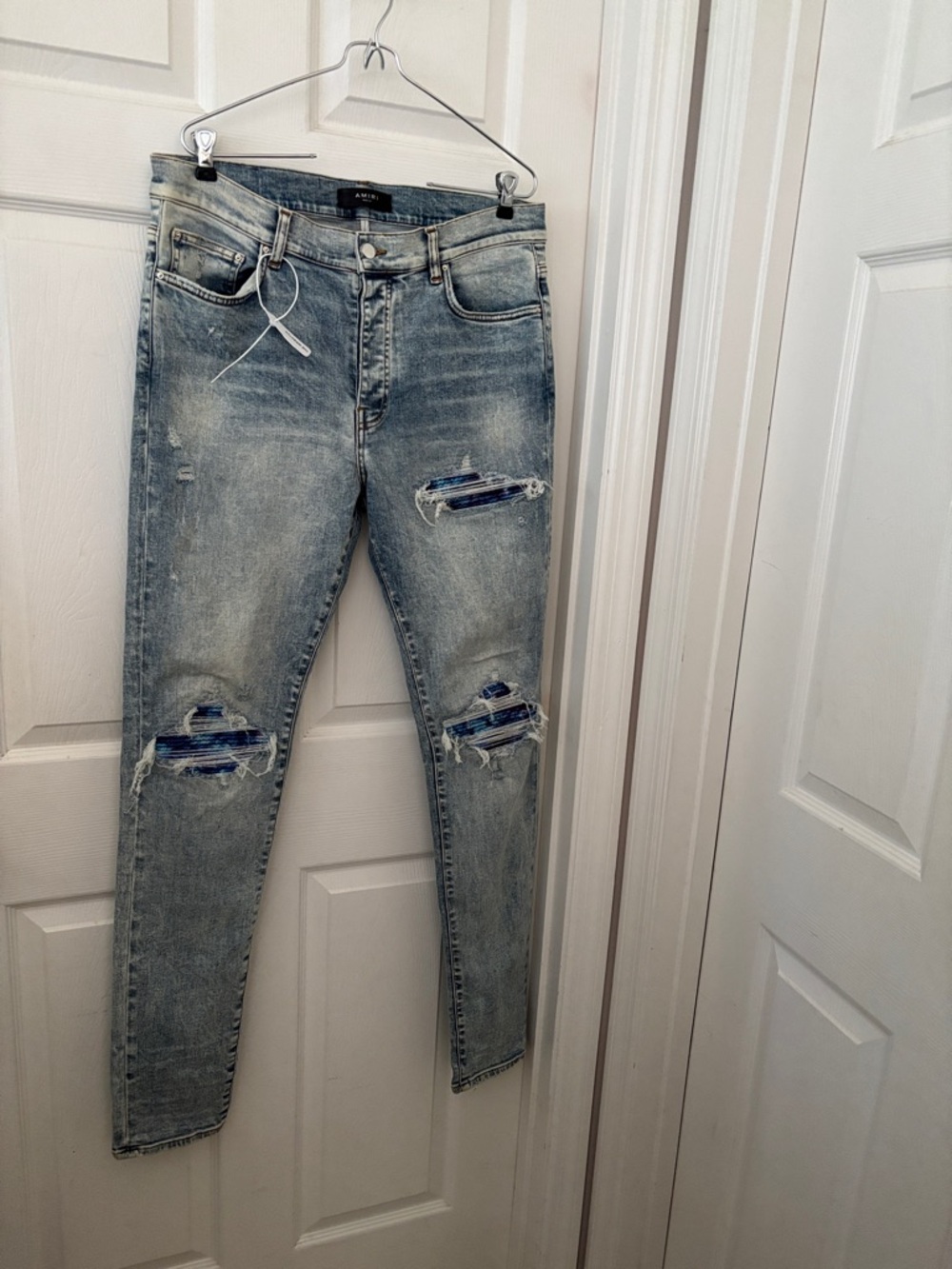 AMIRI Light Blue Distressed Skinny Jeans with Patch Details